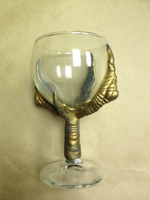 Glass goblet with gold fingers